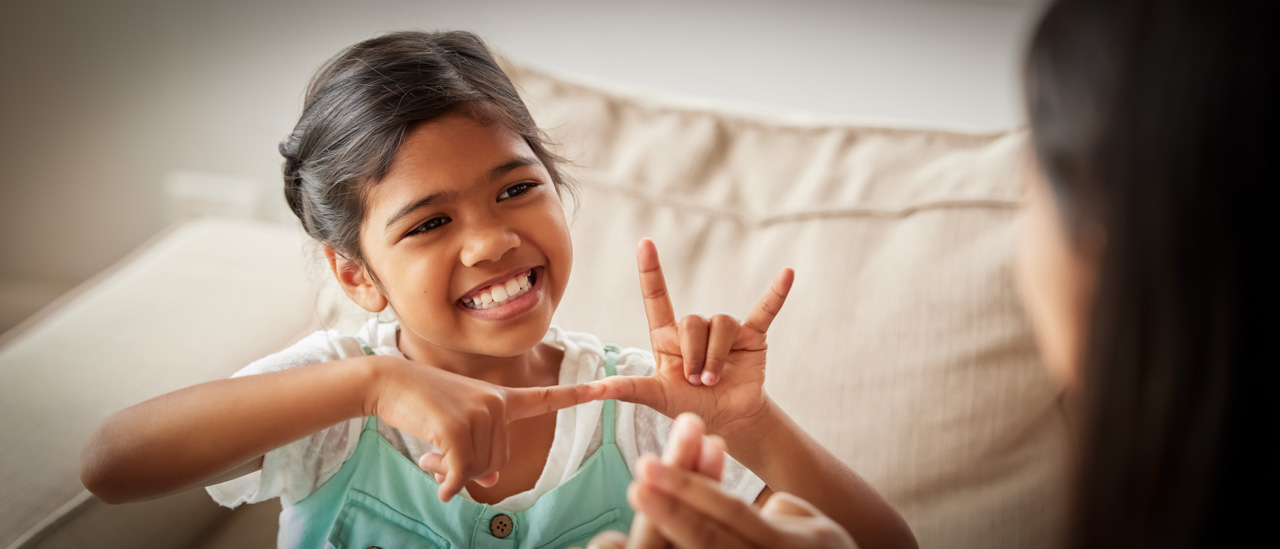 Little girl using sign language to communicate with her mother