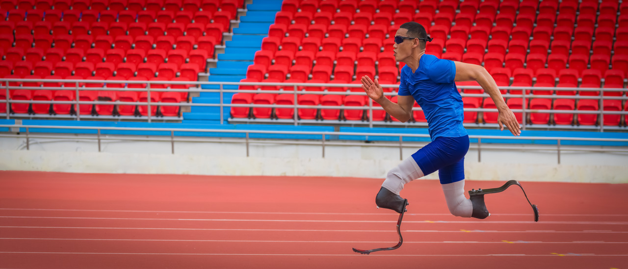 Athlete speeds up on stadium track, aiming to break his record with prosthetic blades