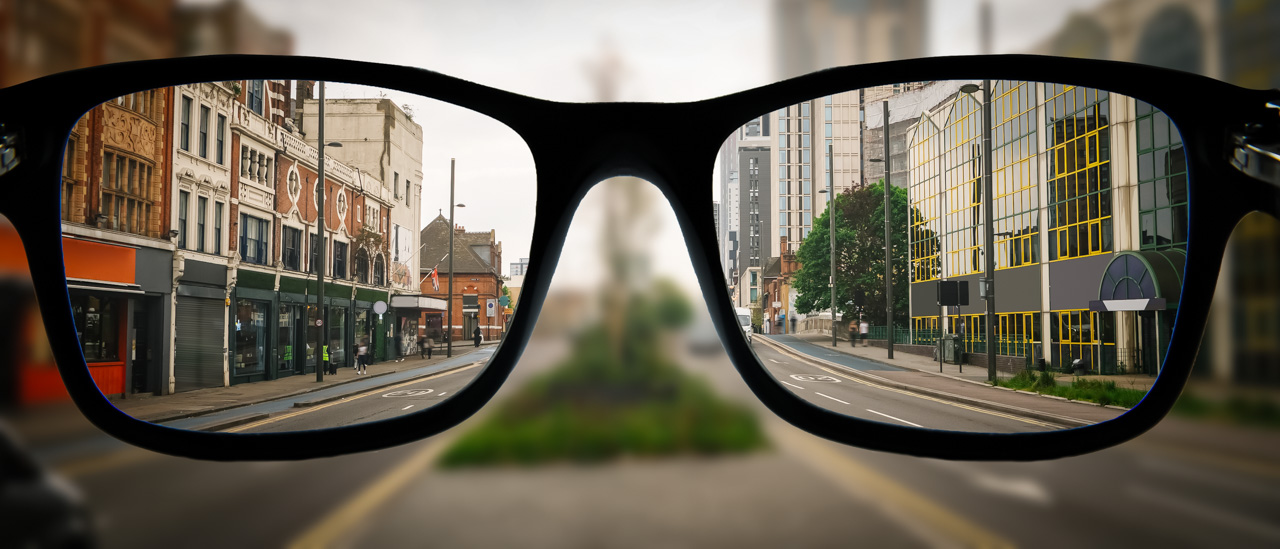 City street seen clearly through eyeglasses, illustrating vision correction and visual clarity.