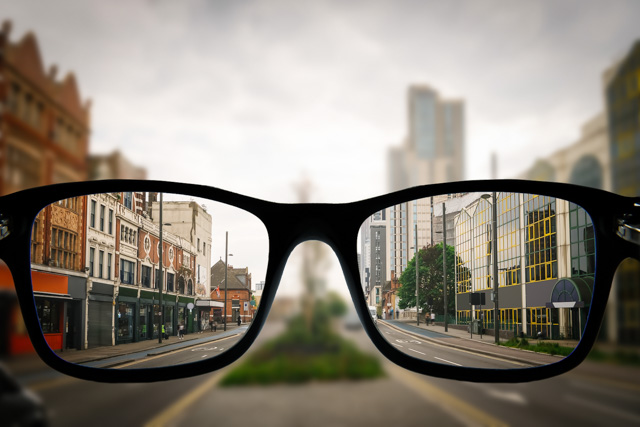 City street seen clearly through eyeglasses, illustrating vision correction and visual clarity.
